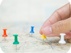 selective focus hand holding pin map background 1 1 e1726473333431